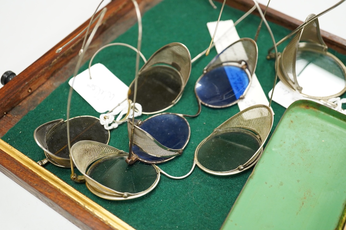 Two pairs of Willson, USA mesh sided safety glasses, and three similar pairs of unmarked glasses one in its original tin case marked BH (5)